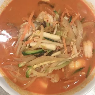 a bowl of soup with a spoon in it