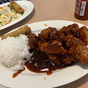Orange chicken with steamed rice and spring rolls