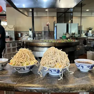 noodles in bowls on a counter