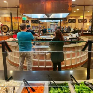 a man and a woman standing in front of a counter