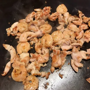 chicken and mushrooms cooking in a wok