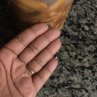 a person's hand holding a stir fry