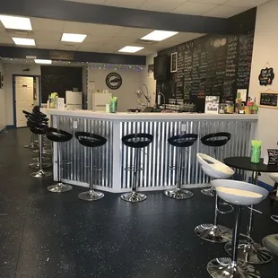 a view of a bar with stools