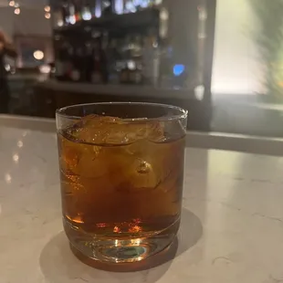 a drink in a glass on a counter