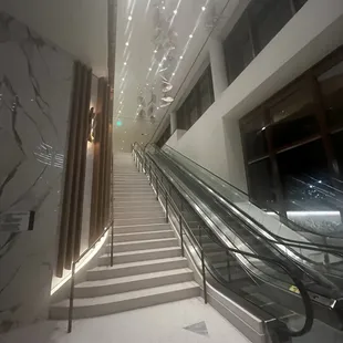 an escalator and stairs in a building