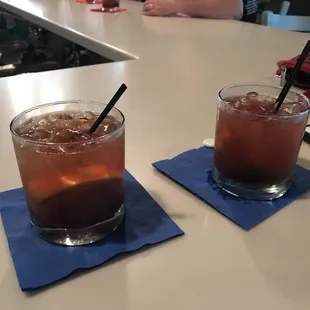 two glasses of iced tea on a table