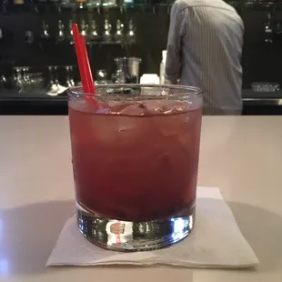 a drink in a glass with a red straw