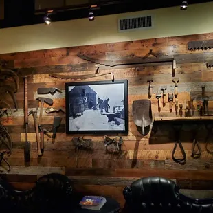 a variety of tools displayed on a wooden wall