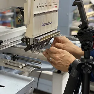 Threading the embroidery machine.