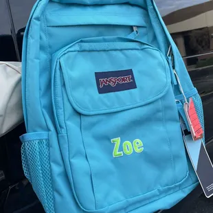 Embroidered name centered on pocket, lime green white outline