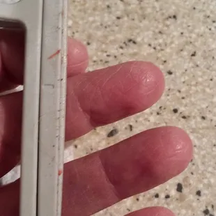 Red, sticky stuff on hoop from what I thought was a new machine.