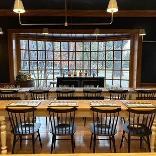  a long table with chairs and a piano