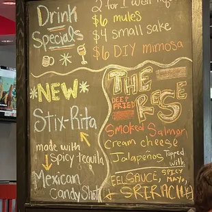 a man sitting in front of a chalk board