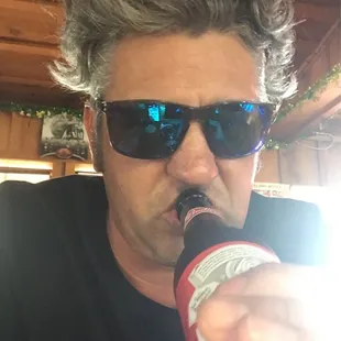a man drinking a beer