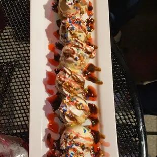 a plate of ice cream sundaes with sprinkles