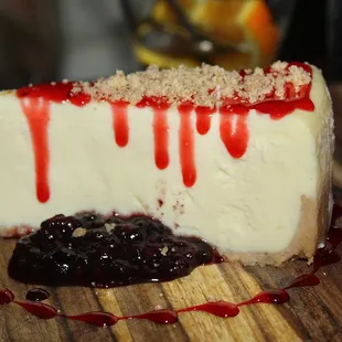 The Cheesecake was served with raspberry coulis and berries.