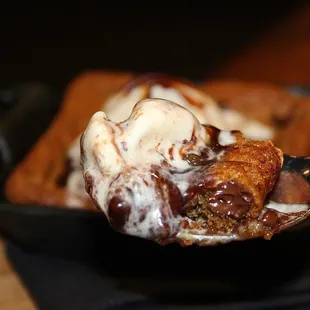 Cookie heaven! The gooey, chewy chocolate chip cookie was served warm in a skillet &amp; topped with cold, vanilla bean ice cream.
