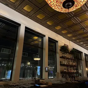 a bar with a chandelier hanging from the ceiling