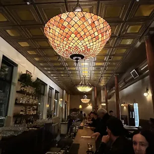 people sitting at a long table in a restaurant