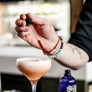 a bartender preparing a drink at a bar