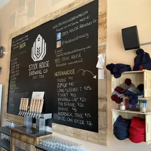 Taproom with chalkboard, taps and merch.