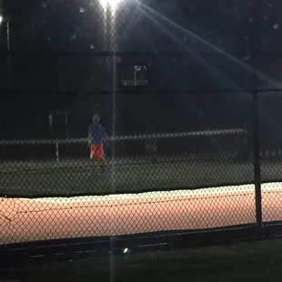 My son playing tennis w another boy... You can't really see him..