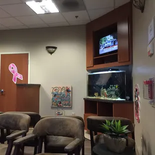 Waiting room has a tv and an aquarium.