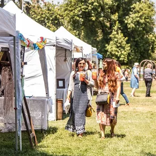 a group of people walking through a market