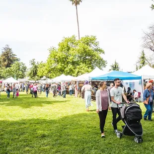 a crowd of people at a farmers market