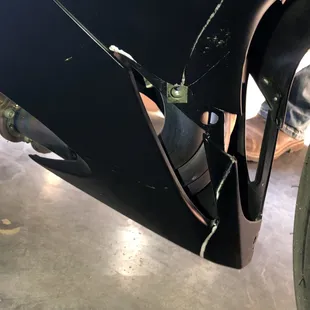 Crack in lower fairing and fluid spilled on newly painted fairing.