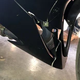 Crack in lower fairing and fluid spilled on newly painted fairing.
