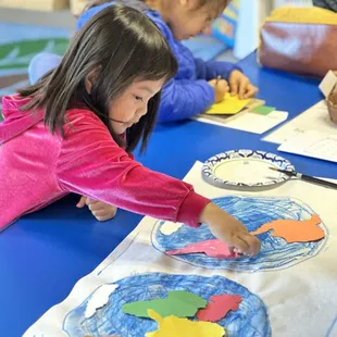Montessori students dive into geography by creating their own world map through hands-on learning--an engaging way to explore continents.
