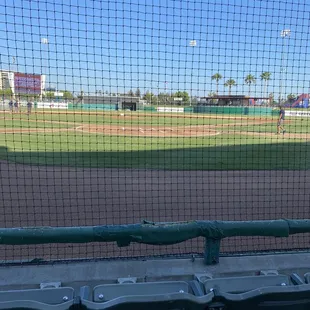 Right behind home plate, full on shade.