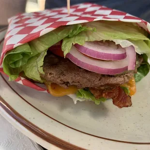 a burger wrapped in a checkered paper