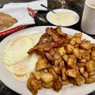 Breakfast Special with eggs, bacon, side of sausage gravy, potatoes, toast, coffee.   Breakfast Special Breakfast Special