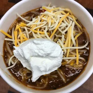 a bowl of chili and cheese