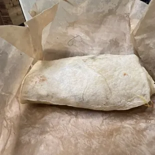 a burrito wrapped in parchment paper