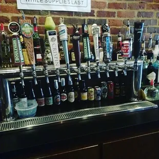a row of beer taps on a bar