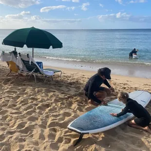 Learning how to prep the board and how to have fun when the surf is low.