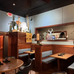 a restaurant with wooden booths and tables