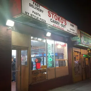 a man walking in front of a restaurant
