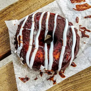 a chocolate donut with white icing