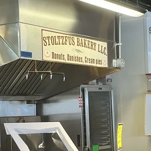 a sign above the kitchen counter