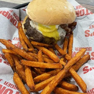 Burger with egg, bacon and avocado with sweet potato fries