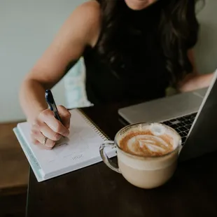 a woman writing in a notebook