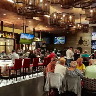 Guests in the bar area enjoy happy hour and live music