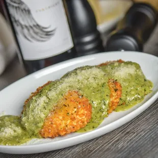 Crispy Ravioli topped with pesto cream sauce