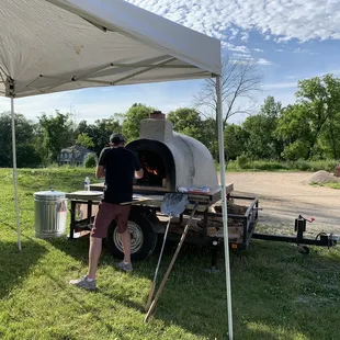 a man cooking a pizza