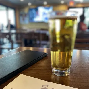 a glass of beer and menu