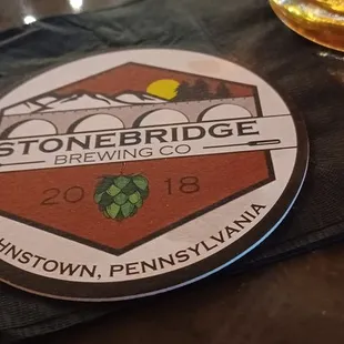 a glass of beer and coaster